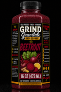 A bottle of Grind Gravitate Beetroot cold and flu remedy, 16 oz (473 ml), featuring a black cap and a black label with red and yellow text, and an illustration of beets, greens, and ginger on a black background.